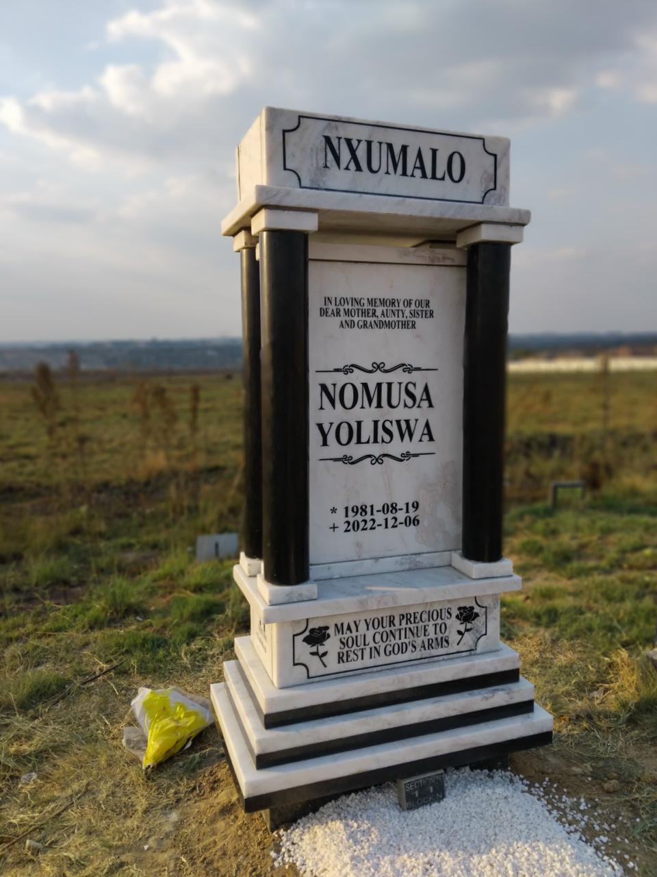 A completed granite memorial in a peaceful setting