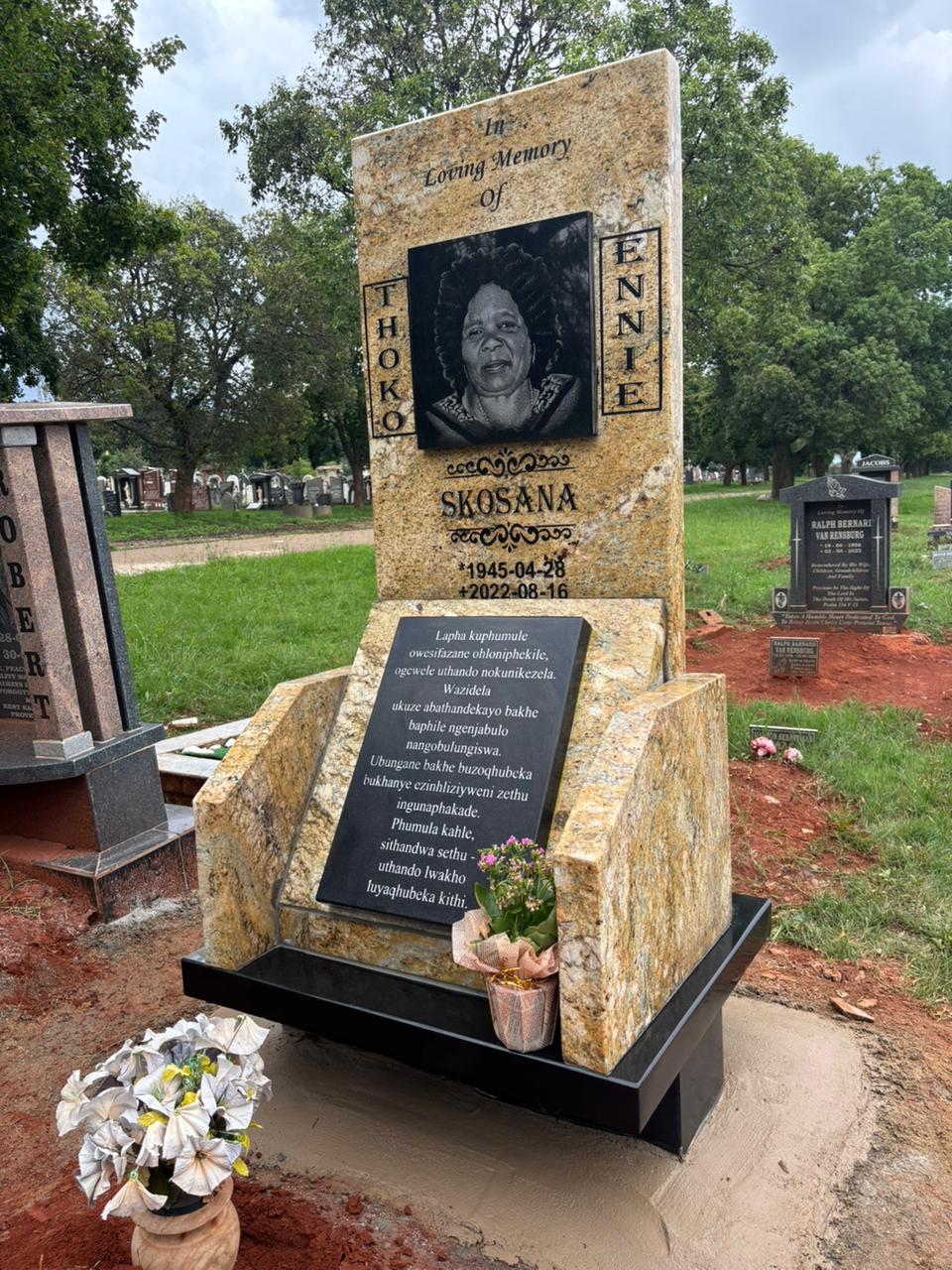 A complete warm gold granite memorial with a personal portrait and engraved plaque